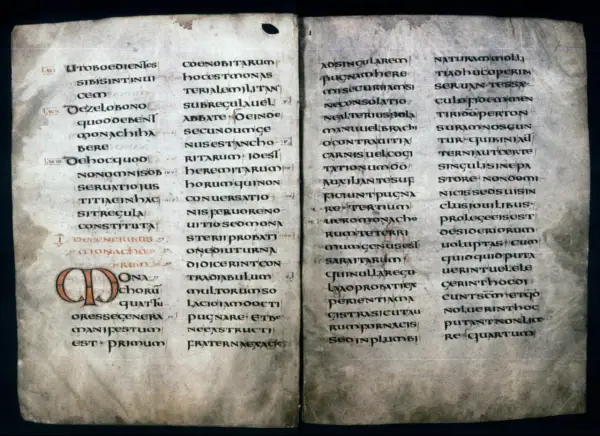Ancient manuscript page with Latin text, likely a St. Benedict prayer, featuring illuminated initial 'O'.